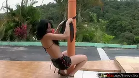 Long legged shemale in black lingerie strips thong outdoors