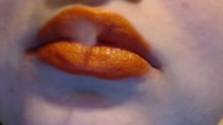 Smoking With Orange Lips and a wicked smirk