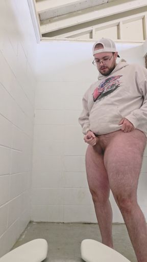 pissing and jerking in a public restroom stall
