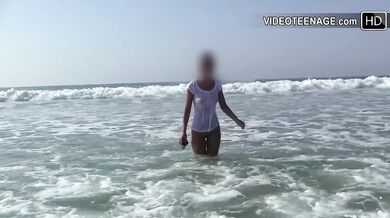 Brunette lost her top at the beach trying to stay dry