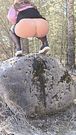 A Baltic girl urinates juicyly with a large stream while stepping on a stone.