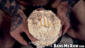 Inked hairy hunk jerks off and shoves his big cock in cake