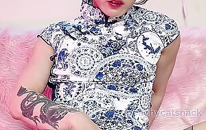Fit cutie in a sexy Chinese dress plays with her wet pussy and big clit and flexes her muscles