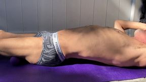 strip and stretch on patio in tight briefs with purple balls and mat