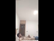 Hairy guy relaxing and masturbating in a hotel room