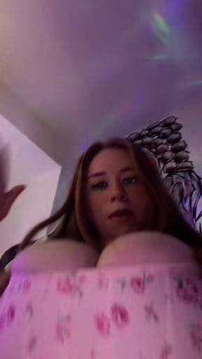 Redheaded beauty with huge tits gets naked and flaunts her body.