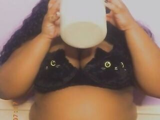 Black with an giant stomach drinking milk