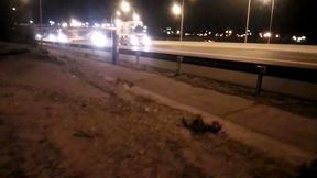 Naked on the road in front of traffic at night