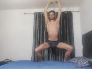 Very very skinny teen stretches out his bones and muscles on his bed
