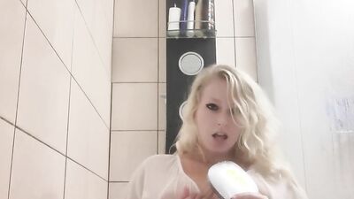 Busty amateur MILF is squeezing her big boobs for you while in a bathroom