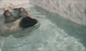 Sissy underwater attempting to perform autofellatio