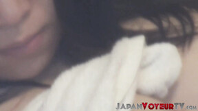 Japanese beauty plays with her aching cunt on voyeur camera