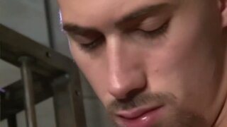 Two Muscular Studs Caged in Passionate Embrace