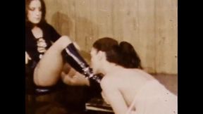 Lesbian Mistress in Leather Dress and Black Boots Dominating a Tender Slave in American Vintage Lezdom Porn Video