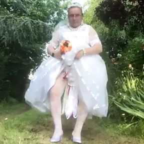 Second white wedding dress in satin and tulle on a walk