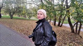 a mature woman with a camera walks about the park, and no one even guesses that she is a famous whore .!. ))