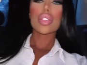 Lara Frost in a secretary costume rides in a car