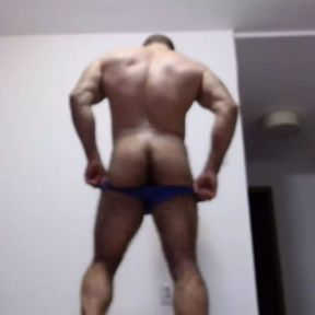 The powerful hairy bodybuilder does a striptease, poses, dances and shows a hairy hole in the ass from very close up