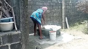 Sexy village girl bathes outside compound, kissed hornyly by black stud