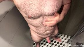 Hairy hunk takes a hot shower after finishing his workout