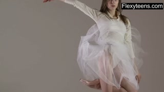 Blonde gymnast performs gymnastics