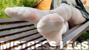 Enjoy seductive nylon feet on a bench in white patterned pantyhose (4K HD)