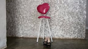 With high heels on her feet and short dress seated woman crosses her big legs (2)