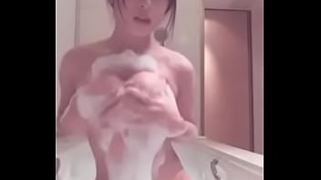 Japanese girl plays with big tits in the bath