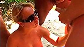 Wild bukkake gangbang for busty MILF on a beach