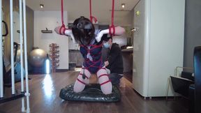 Girl in white tights suspended by red ropes, inflatable gag, inflation experiment.