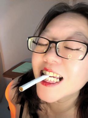 Cute blonde girl smokes a white Dunhill menthol cigarette