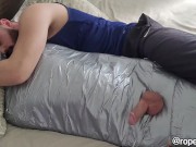 bearded dom using mummified boy as a toy