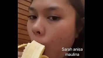 Asian girl sucking banana for fun