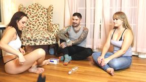 Two girls and a guy play a naked spin the bottle game