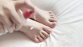 Plus size female takes care of her thick feet, smothering her arches, small toes and wrinkly soles in lotion