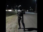 doubled cocked masked wetsuited guy jerking off outside