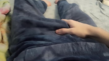 A guy in blue pants is jerking off