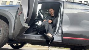 A girl in high-heeled shoes plays with the pedals of a car, first-person and cameraman video