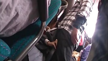 A horny man is putting his fingers in a young Japanese babe’s panties, while in the bus