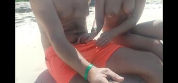 On the beach, a stranger gives a handjob in public