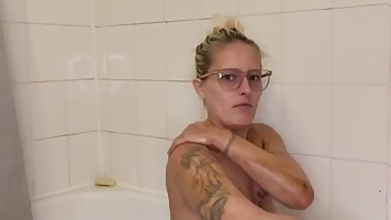 Amateur blonde MILF with glasses taking bath