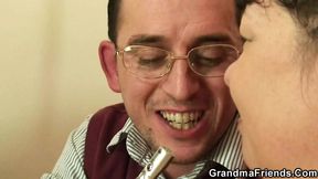 Busty brunette granny gets two dicks