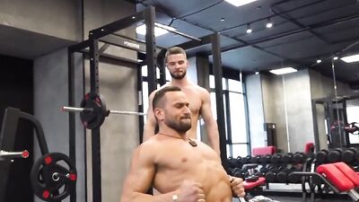 Two beefed dudes enjoy in some action during a workout