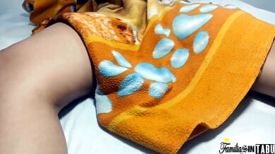 Light-skinned brunette explores her wet pussy on a white bed with patterned blankets