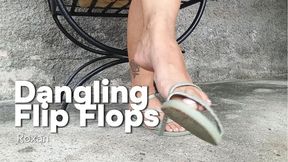 Flip flops hang from Roxan's feet (3)