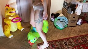 a girl in lingerie with bare feet tramples inflatable dinosaurs hard, steps on them, tramples them, walks, crushes them, jumps, sits on them, sits on their face foot fetish crash fetish dominance legs