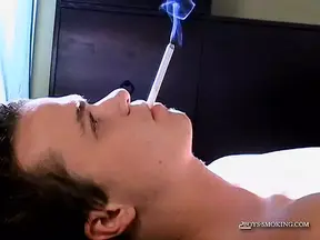 Slim deviant Holden strokes cock and cums while smoking