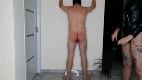 BDSM session. Dominatrix Nika spanked a slave on bare ass and whipped him on the back
