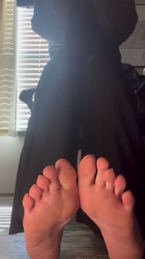 candid removing dirty socks under desk to reveal tasty soles during work