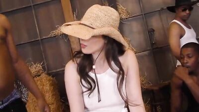 Brunette cowgirl kneels between hung black guys for a gangbang